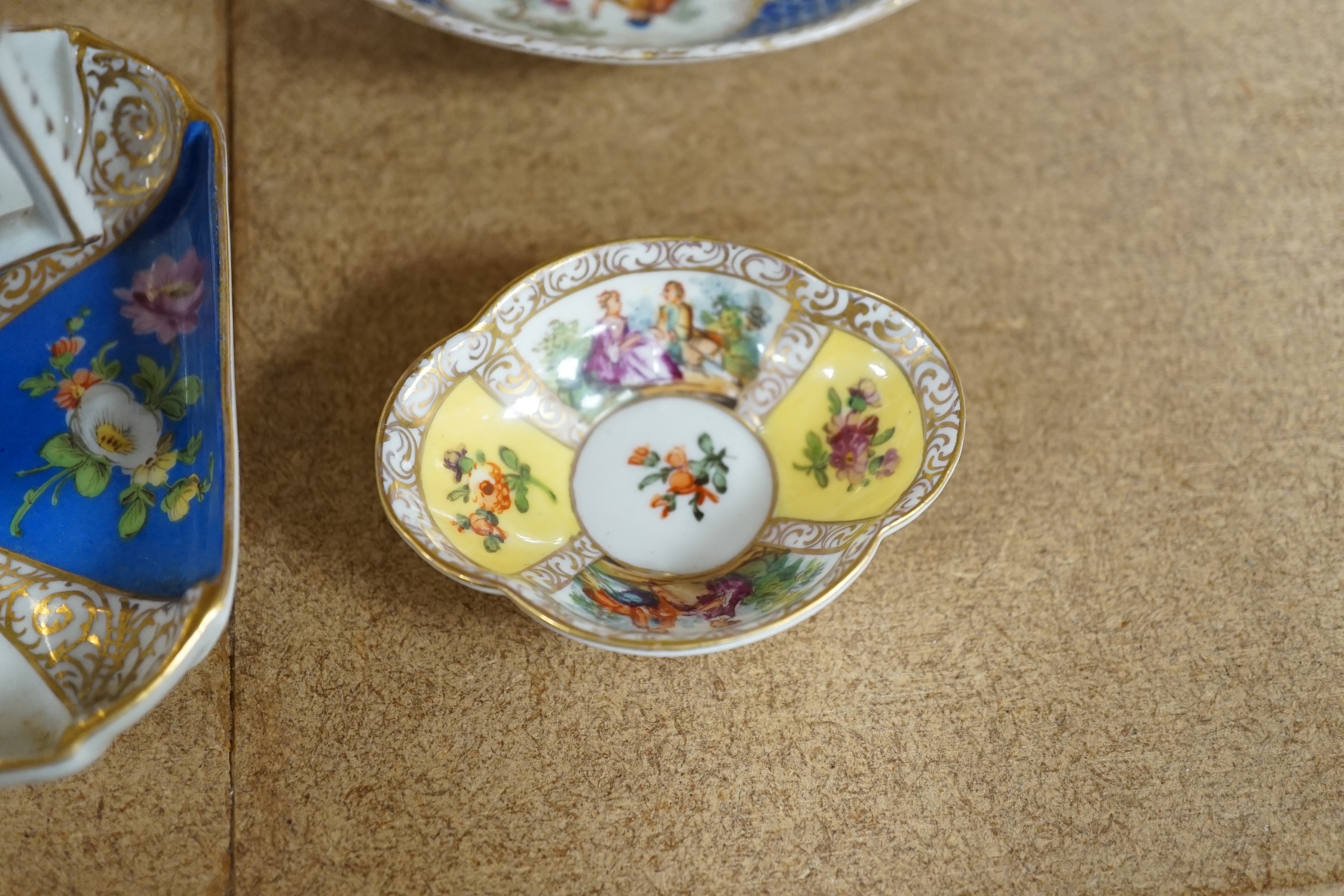 A Crown Dresden porcelain cup and trembleuse saucer, and three other Crown Dresden cups and saucers, largest 14.5cm wide. Condition - good